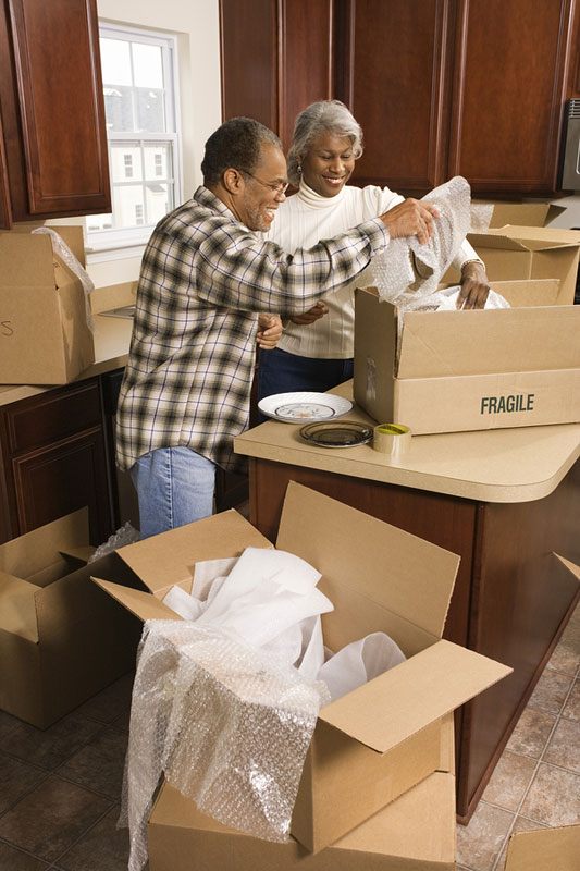 Couple packing kitchen